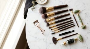 A high-end, editorial-style flat lay of premium makeup brushes and professional beauty tools arrange